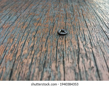 The Single Screw Is Embedded In The Old Wood.