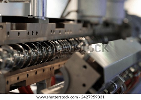 Single screw plastic extruder machine close up. Selective focus.