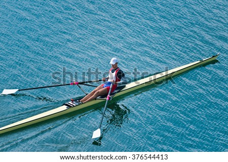 Single scull rowing competitor