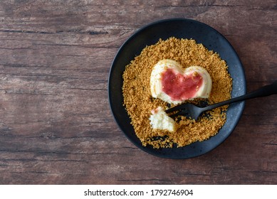 Single Serving Of Heart Shaped Creamy Italian Cheesecake On Graham Cracker Crumbles
