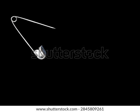 A single sharp open silver pin 