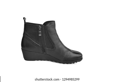 Single short black leather women’s boot isolated on white background. Short demi-season shoes, fashion and shopping concept