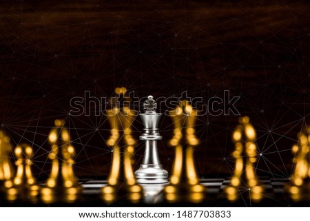 single silver king chess surrounded by a number of gold chess pieces and abstraction connection line network screen, business strategy concept
