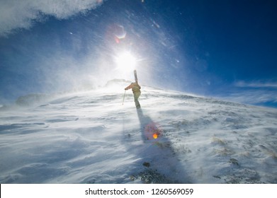 A Single Skier Hiking In Strong Winds To The Top Of Palmyra Peak On The Telluride Ski Resort
