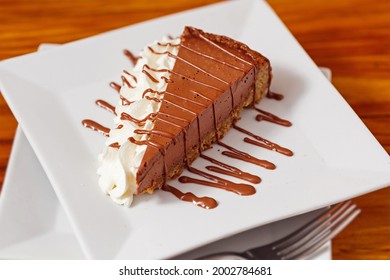 Single Slice Of Italian Chocolate Walnut Torte With Whipped Cream