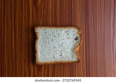 Single Slice of White Bread on Wood