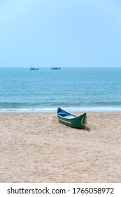 Single Small Catamaran Boat Parked On Beach Shoreline