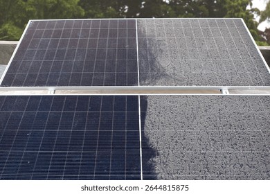 A single solar panel, half cleaned and half covered in accumulated dust, dramatically illustrating the impact of dirt on solar energy efficiency.
