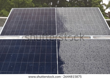 A single solar panel, half cleaned and half covered in accumulated dust, dramatically illustrating the impact of dirt on solar energy efficiency.