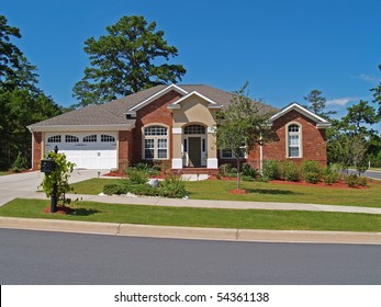 Single story brick residential home with the garage in the front.