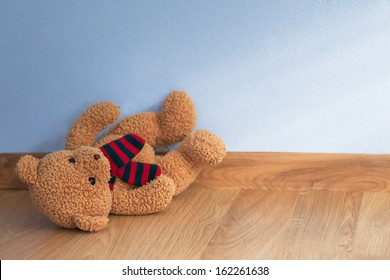 Single Teddy Bear On A Floor In A Child Room