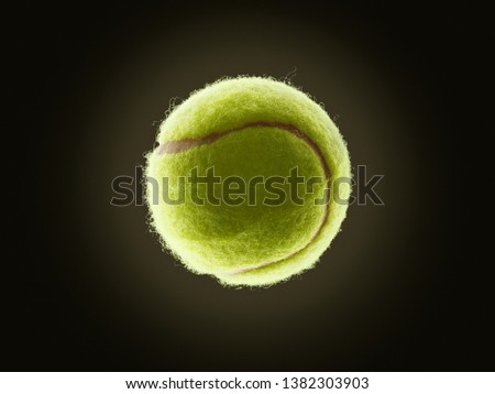 single tennis ball with eclipse like effect on a dark background