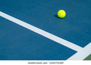 A Single Tennis Ball On a Tennis Court - Great Photo For Tennis or Sports Related Promotions