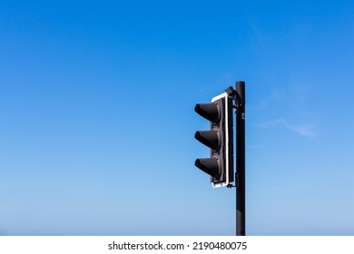 Single Traffic Light Or Stop Light Against A Clear Blue Sky With Copy Space