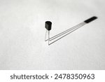 Single transistor and its shadow. Semiconductor electronic component.