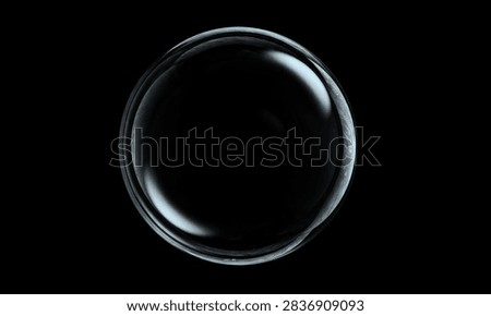 A single transparent soap bubble floating against a solid black background