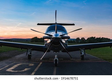 Single turboprop aircraft on evening runway after sunset. A single-engine plane is parked on the runway, bathed in the evening sun. Beautiful color view of the plane. - Shutterstock ID 1914678751