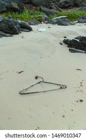 Single use plsatic garbage litter on beach. Rubbish and waste found on beautiful sand beach while on holiday in Galapagos Islands. Environmental, pollution, waste, climate change, problem concepts.