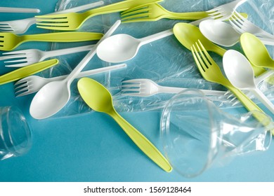 Single use spoons, forks and cups, Disposable tableware, Plastic pollution, waste, eco, ecology, recycle. Plastic processing problem