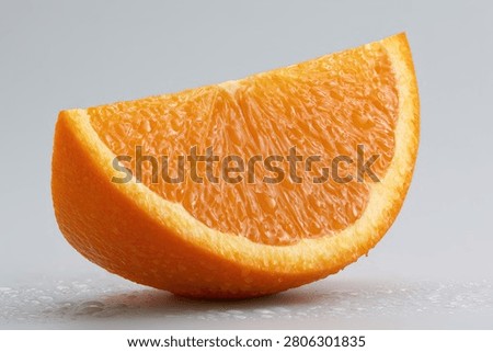 A single, vibrant orange slice is presented in a close-up view, showcasing its textured pulp and bright rind against a clean, neutral backdrop.
