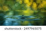 A single water drop creates ripples in still water with a blurry green background