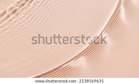 Single wave making ripples on water surface on beige background | products background, cleanser commercial