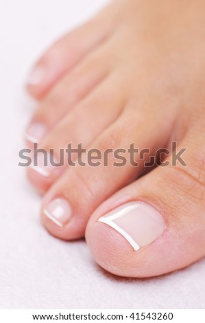 Single well-groomed female foot with a french pedicure. Close-up toy.