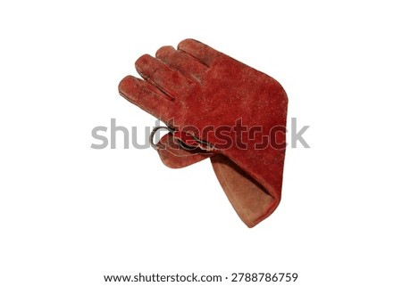 A single, well-worn, red leather work glove with visible dirt and scuffs, isolated on a white background
