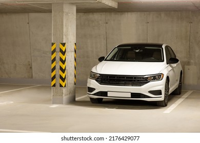 Single White Car In An Empty Parking Lot In An Underground Parking