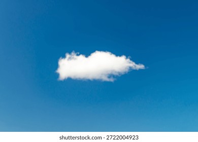 Single white cloud floating in clear blue sky with minimal background