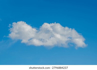 Single White Cloud Floating In Clear Blue Sky