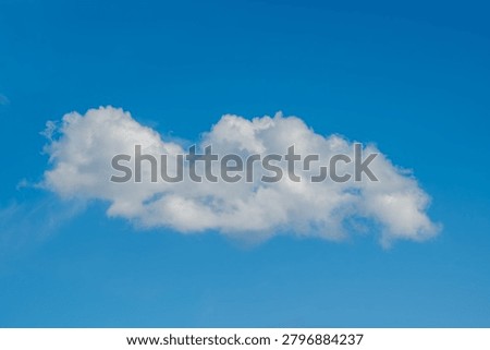 Single White Cloud Floating In Clear Blue Sky