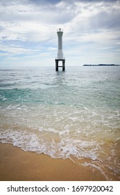 A single white light post beacon standing in a crystal blue sea in a virgin beach in West Sumatra Indonesia