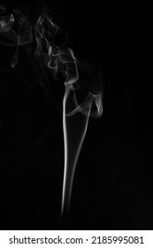 A Single White Smoke Burn From Incense, Shot In Studio With Dark Black Background, For Design And Religion Concept