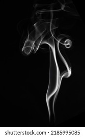 A Single White Smoke Burn From Incense, Shot In Studio With Dark Black Background, For Design And Religion Concept