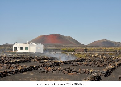 Single White Spanish Bungalow In Width Of Black Volcanic Landscape On Canary Island Lanzarote, Spain