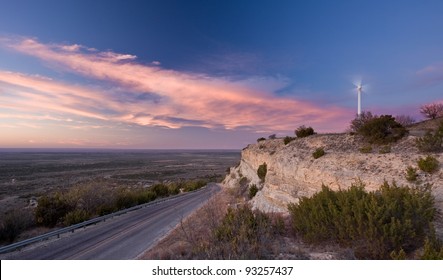 A single wind turbine on a ridge in west Texas during sunset