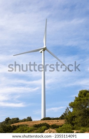 Single wind turbine tower in an eolic park in Spain. Windmills power and renewable energy.