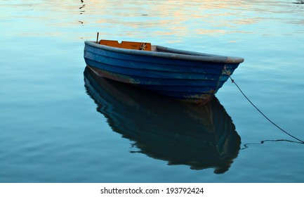A single wooden boat on the water.