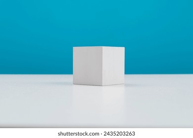 Single wooden cube on table