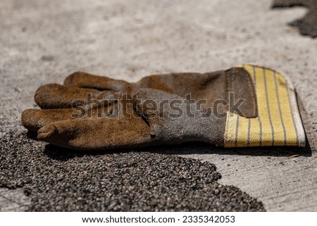 a single work glove on a street