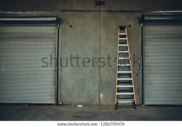 Single Yellow Ladder Leaning Against Concrete Stock Photo Edit