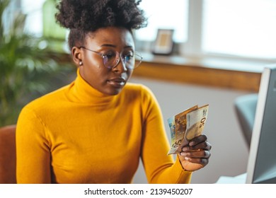 Single Young African Housewife With Many Debts Feeling Stressed, Calculating Finances, Sitting At Table With Papers, Trying To Make Both Ends Meet, Not Able To Pay Off Bills