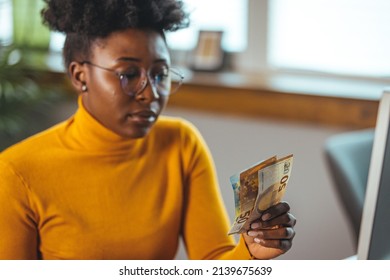 Single Young African Housewife With Many Debts Feeling Stressed, Calculating Finances, Sitting At Table With Papers, Trying To Make Both Ends Meet, Not Able To Pay Off Bills