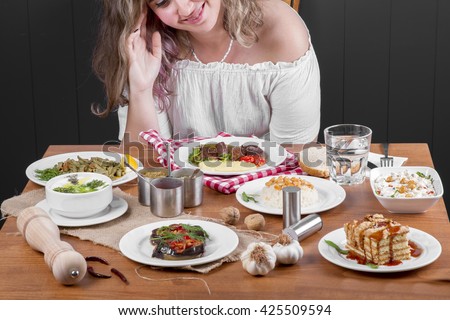 Single Young Beautiful Curly Hair Woman waiting before have dinner, sitting alone at the table 