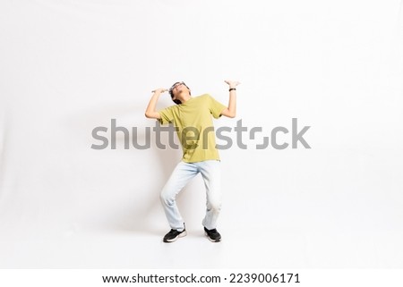Single young males try to hold weight. The full body of an Asian or Indonesian person. Isolated photo studio with white background.