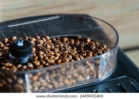 Singleorigin coffee beans like Kapeng barako or Jamaican Blue Mountain coffee, stored in a clear container with a black lid, are essential ingredients for delicious java cuisine