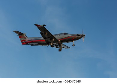 Single-propeller aircraft flying over the runway at a small airport. Single turboprop aircraft landing aircraft.