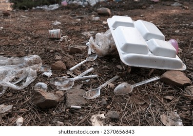 Single-use plastic cutlery left to nature. Polycarbonate trays used in takeaways.  - Shutterstock ID 2370656843