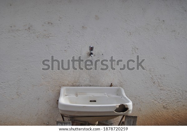 sink in the dirty white\
wall